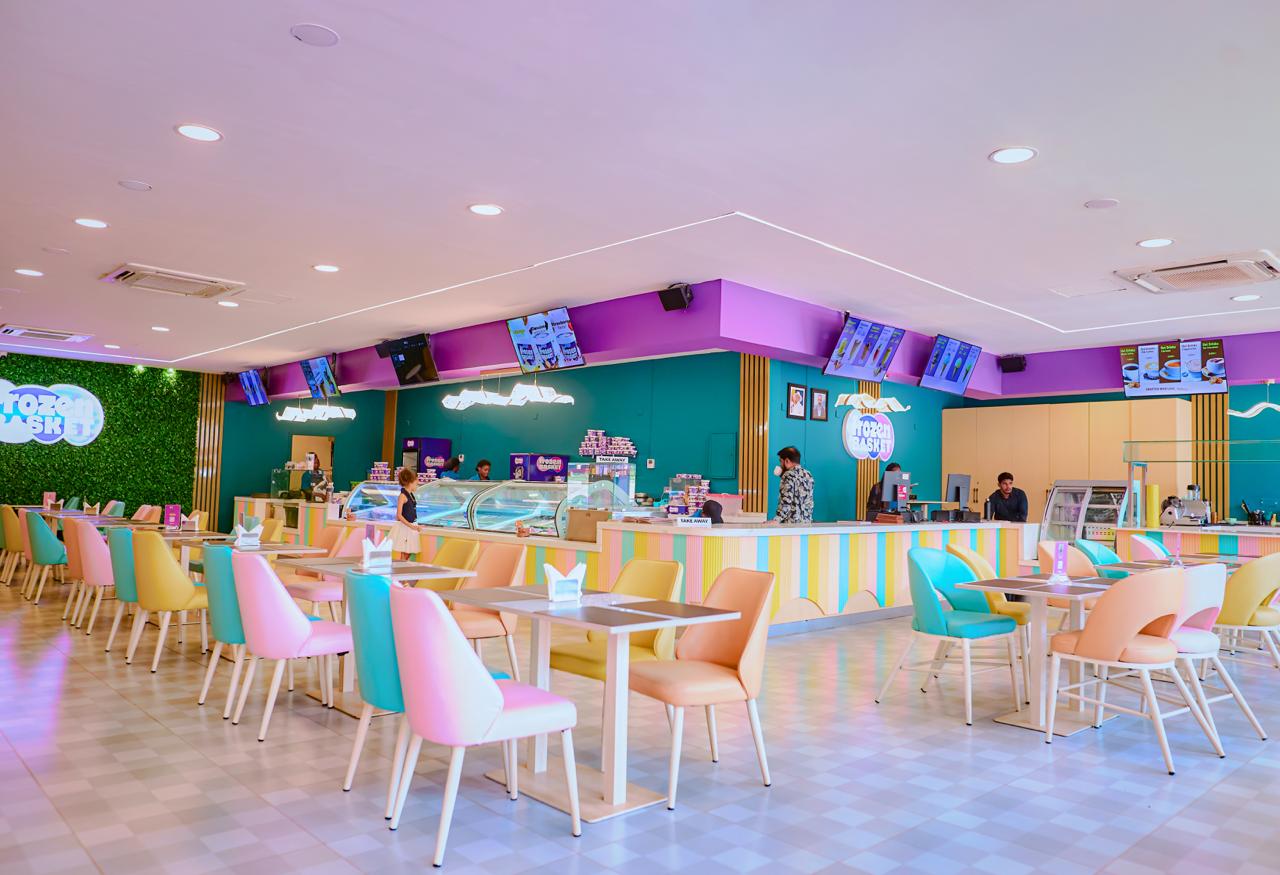 Rows of mint, peach and pink chairs across the dining room